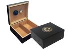 Two humidors in black finish one is open showing a humidifier and hygrometer the other one is closed with the US Coast Guard engraved on top